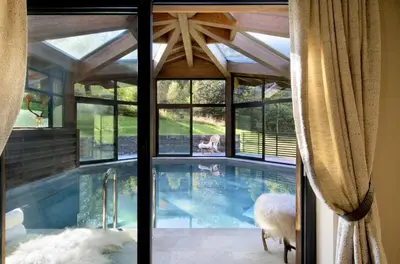 a swimming pool in a house with a large window at Chalet Alta in Chamonix-Mont-Blanc
