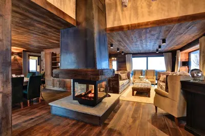 a living room with a fireplace in a house at Chalet Alta in Chamonix-Mont-Blanc