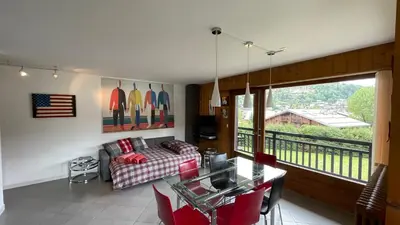 a living room with a couch and a table at Flocon U Bon Slo Megeve 2 in Megève