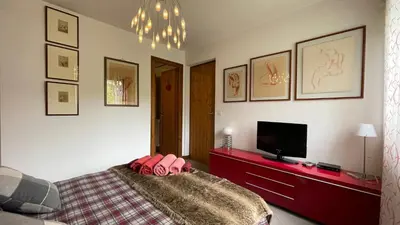 a bedroom with a bed and a flat screen tv at Flocon U Bon Slo Megeve 2 in Megève