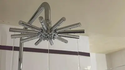 a silver ceiling fan is hanging from a ceiling at Flocon U Bon Slo Megeve 2 in Megève
