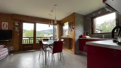 a kitchen with a table and chairs with a view at Flocon U Bon Slo Megeve 2 in Megève
