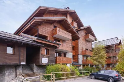a building with a car parked in front of it at Résidence Les Fermes du Soleil - maeva Home - Appartement 3 pièces 6 personnes - Prestige MAE-4281 in Arâches-la-Frasse
