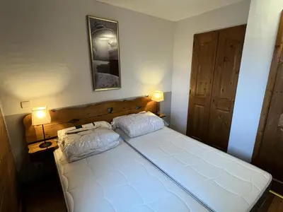 a bedroom with a large white bed with two pillows at Résidence Les Fermes du Soleil - maeva Home - Appartement 3 pièces 6 personnes - Prestige MAE-4281 in Arâches-la-Frasse