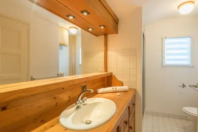 a bathroom with a sink and a mirror at Appartement Cimes Étoilées - Welkeys in Megève