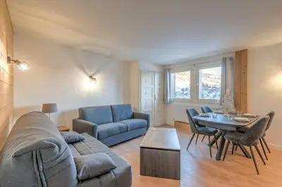 a living room with a couch and a table at Appartement Cimes Étoilées - Welkeys in Megève