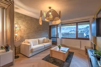 a living room with a couch and a table at Appartement Alpestre - Welkeys in Combloux