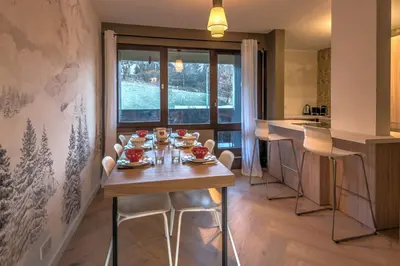 a kitchen with a wooden table with food on it at Appartement Alpestre - Welkeys in Combloux