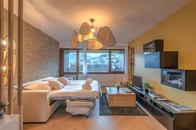 a bedroom with a bed and a tv in it at Appartement Alpestre - Welkeys in Combloux