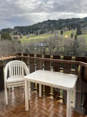 a white table and a chair on a balcony at Mignon petit Studio 25m2 avec balcon et Parking face départ pistes ! in Demi-Quartier