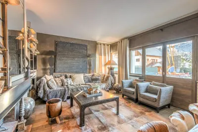 a living room with a couch and chairs and a table at Appartement Hermine - Welkeys in Megève