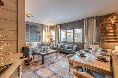 a living room with a couch and a table at Appartement Hermine - Welkeys in Megève