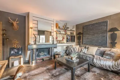 a living room with a couch and a fireplace at Appartement Hermine - Welkeys in Megève