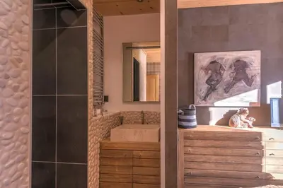 a bathroom with a sink and a mirror at Appartement Hermine - Welkeys in Megève