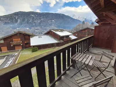 a resort with a swimming pool and mountains in the background at Au coeur des Alpes in Saint-Gervais-les-Bains