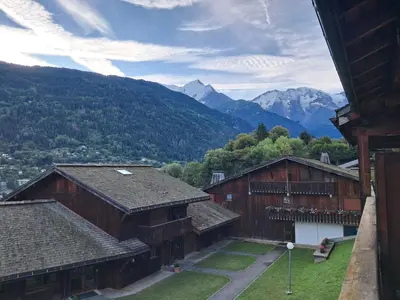 a view of some buildings with mountains in the background at Au coeur des Alpes in Saint-Gervais-les-Bains