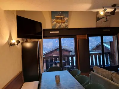 a chair on a balcony with a view of mountains at Au coeur des Alpes in Saint-Gervais-les-Bains