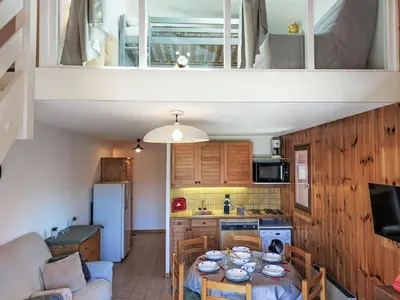 a living room with a table and a kitchen at Apartment La coupe de Cristal by Interhome in Saint-Gervais-les-Bains