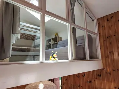 a stuffed animal sitting in the window of a bedroom at Apartment La coupe de Cristal by Interhome in Saint-Gervais-les-Bains