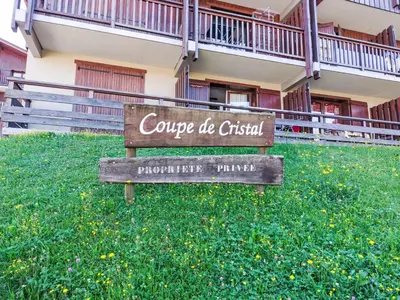 a table and two chairs on a balcony with mountains at Apartment La coupe de Cristal by Interhome in Saint-Gervais-les-Bains