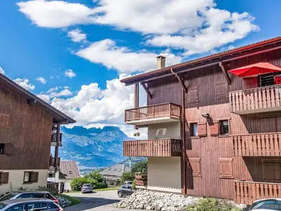 a building with balconies and mountains in the background at Apartment La coupe de Cristal by Interhome in Saint-Gervais-les-Bains