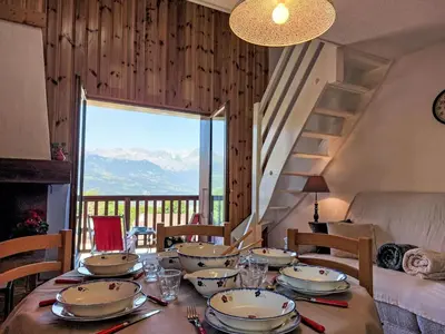 a kitchen with a table with chairs and a television at Apartment La coupe de Cristal by Interhome in Saint-Gervais-les-Bains