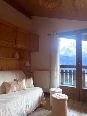 a bedroom with a bed and a view of a mountain at Au cœur des pistes in Saint-Gervais-les-Bains
