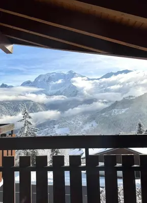 a view of a snowy mountain from a window at Au cœur des pistes in Saint-Gervais-les-Bains