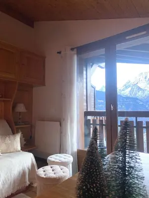 a bedroom with a bed and a table with christmas trees at Au cœur des pistes in Saint-Gervais-les-Bains