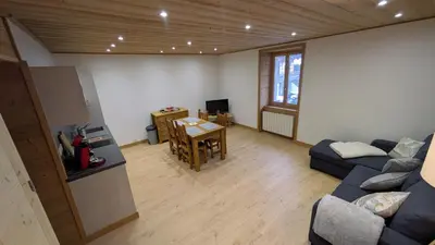 a living room with a couch and a table at L'Helvetia in Chamonix-Mont-Blanc