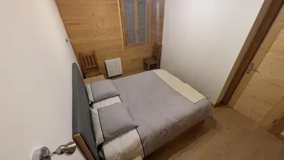 a bedroom with a bed in a small room at L'Helvetia in Chamonix-Mont-Blanc