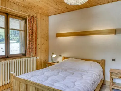 a bedroom with a large bed and a window at Appartement 2 pièces avec 3 balcons et wifi à Megève Centre - FR-1-453-322 in Megève