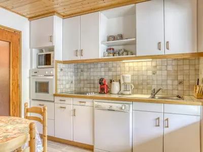 a kitchen with white cabinets and a sink at Appartement 2 pièces avec 3 balcons et wifi à Megève Centre - FR-1-453-322 in Megève