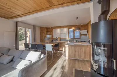 a kitchen and living room with a couch and a refrigerator at Chalet 8 personnes in Passy