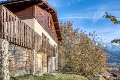 an exterior view of a building with mountains in the background at Chalet 8 personnes in Passy