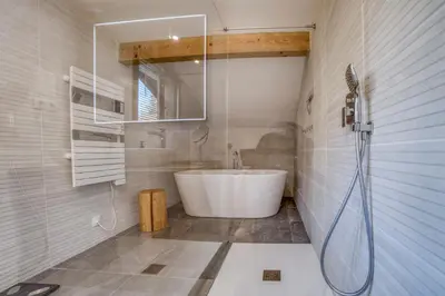 a bathroom with a white tub and a shower at Chalet 8 personnes in Passy