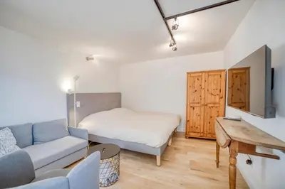 a living room with a couch and a bed at Studio 2 personnes in Passy