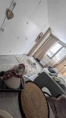 a bedroom with a stuffed animal sitting on a bed at L'Oursina in Chamonix-Mont-Blanc