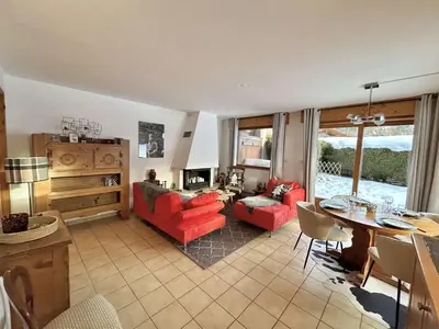 a living room with red furniture and a table at Charmant appartement 3 pièces, jardin, parking et wifi à Demi-Quartier - FR-1-597-187 in Demi-Quartier