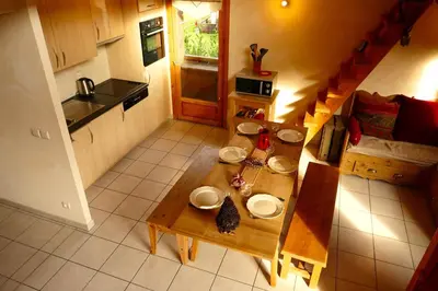 an overhead view of a kitchen with a wooden table at 3 chambres - 2 SDB - 7 personnes - 100 m télécabine GME in Samoëns