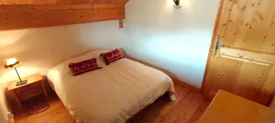 a bedroom with a bed with two pillows on it at 3 chambres - 2 SDB - 7 personnes - 100 m télécabine GME in Samoëns