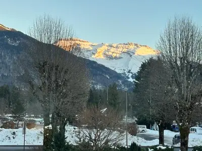 a snow covered mountain in front of a parking lot at 3 chambres - 2 SDB - 7 personnes - 100 m télécabine GME in Samoëns