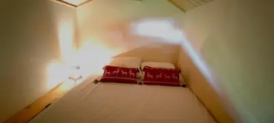 two red pillows on a bed in a small room at 3 chambres - 2 SDB - 7 personnes - 100 m télécabine GME in Samoëns