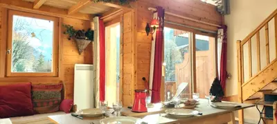 a room with a table in a wooden house at 3 chambres - 2 SDB - 7 personnes - 100 m télécabine GME in Samoëns
