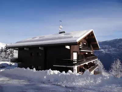 a building covered in snow with snow around it at Le Saphir - Vue spectaculaire sur les Montagnes in Saint-Gervais-les-Bains