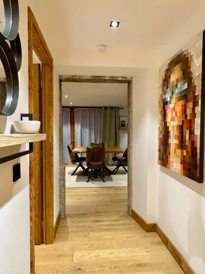 a hallway leading to a dining room with a table at Woodpecker Appartement au coeur du village in Les Houches