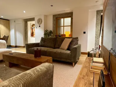 a living room with a couch and a coffee table at Woodpecker Appartement au coeur du village in Les Houches