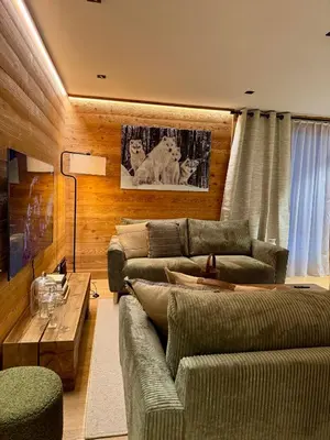 a living room with a couch and a table at Woodpecker Appartement au coeur du village in Les Houches