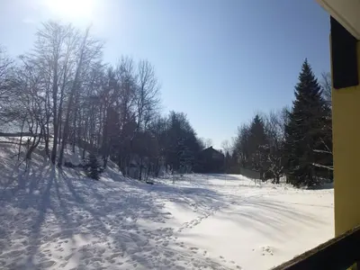 a snowy road with footprints in the snow at Joli studio aux Carroz d'Arâches in Arâches-la-Frasse