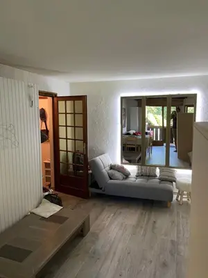 a living room with a couch and a table at Grand studio Combloux - Vue Mont Blanc in Combloux